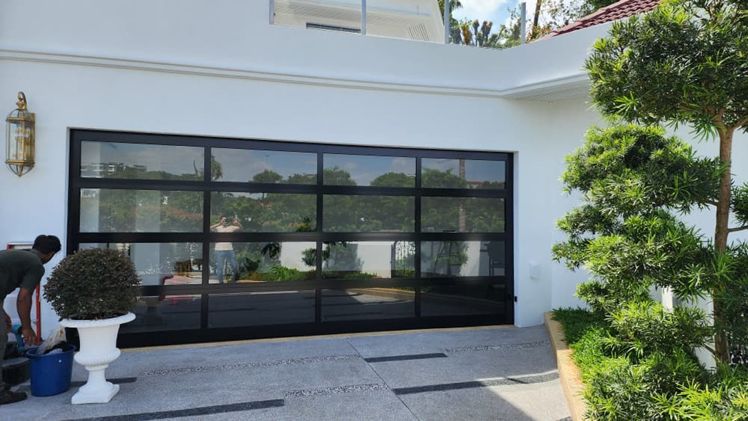 Luxury residential garage with glass sectional door and modern architectural exterior design Malaysia